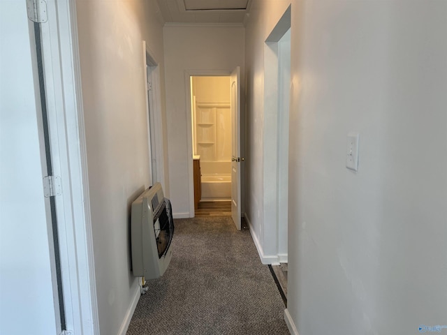 corridor with heating unit and dark carpet