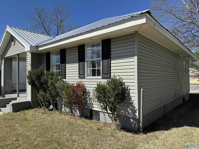 view of side of home featuring a lawn