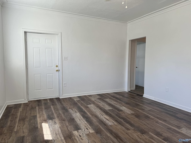 unfurnished room featuring ornamental molding and dark wood-type flooring