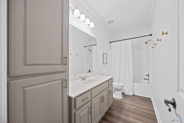 bathroom with vanity, wood finished floors, visible vents, ornamental molding, and toilet