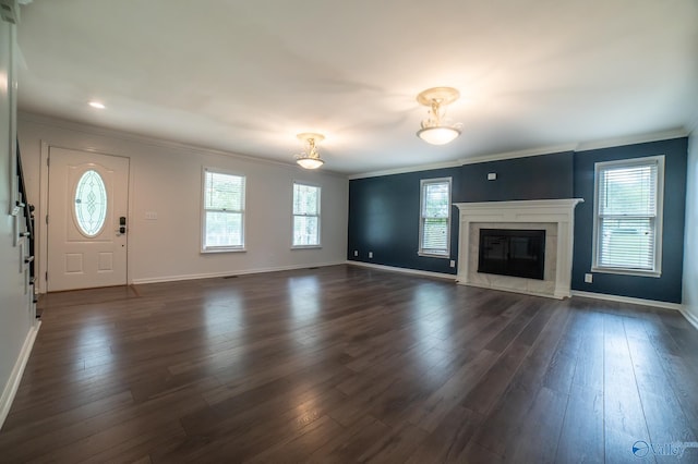 unfurnished living room with crown molding, dark wood-type flooring, and a fireplace