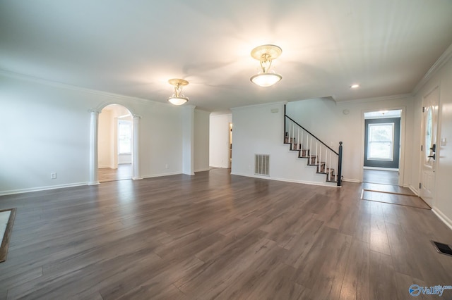 unfurnished living room with dark wood-type flooring and crown molding