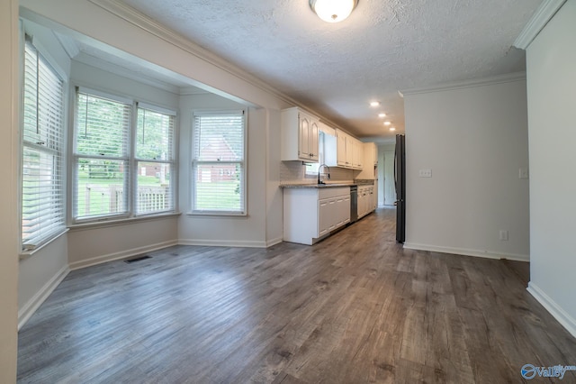 kitchen featuring sink, white cabinetry, dark hardwood / wood-style floors, ornamental molding, and black fridge