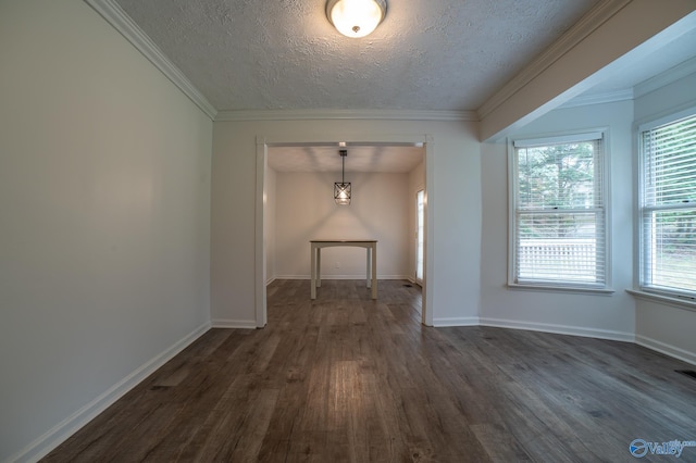 empty room featuring crown molding, dark hardwood / wood-style floors, and a textured ceiling