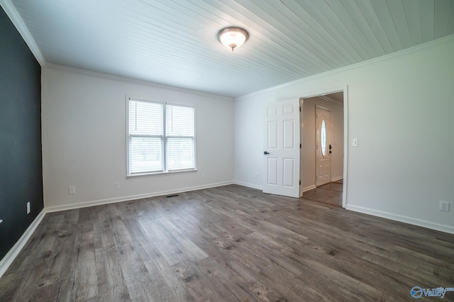 empty room with crown molding and dark hardwood / wood-style flooring