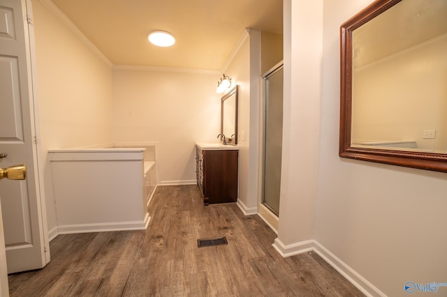 bathroom with ornamental molding, shower with separate bathtub, hardwood / wood-style floors, and vanity