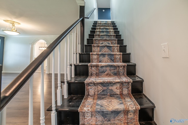 stairs featuring hardwood / wood-style floors