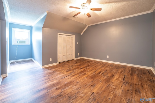 bonus room featuring ceiling fan, hardwood / wood-style flooring, vaulted ceiling, and a textured ceiling