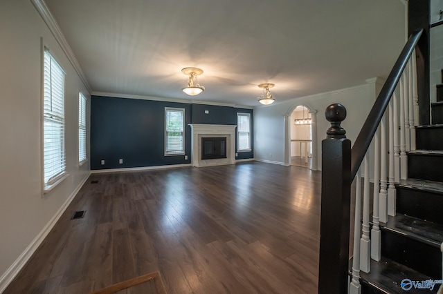 unfurnished living room featuring ornamental molding, a fireplace, and dark hardwood / wood-style flooring