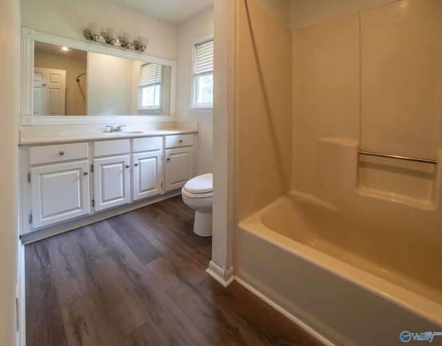 full bathroom featuring shower / bathtub combination, vanity, toilet, and hardwood / wood-style floors