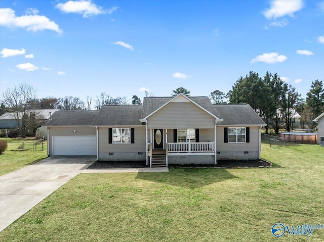 ranch-style home featuring a garage, crawl space, a trampoline, a porch, and a front yard