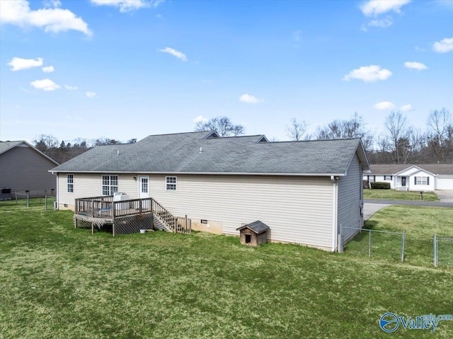 rear view of property with crawl space, a lawn, and a wooden deck