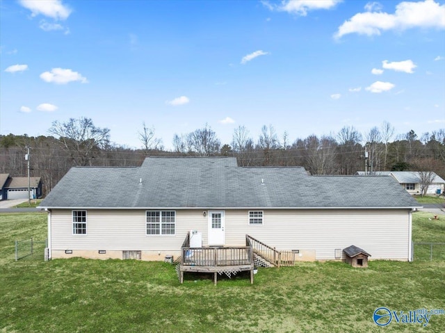 rear view of property featuring a deck and a lawn