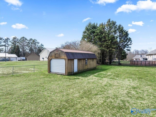 view of yard with fence and an outdoor structure