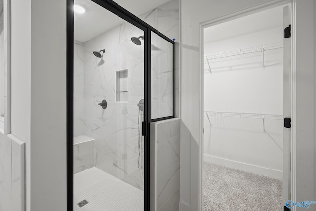 bathroom with a shower with door