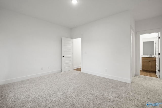 carpeted spare room with sink