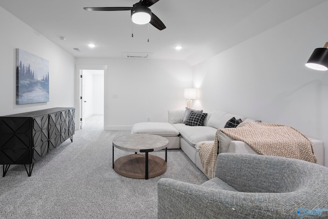 carpeted living room with ceiling fan