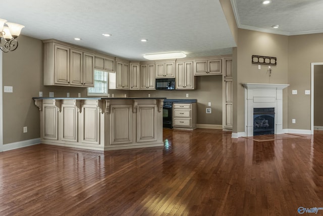 16121 Kyle Moran Dr, Athens, AL 35614 - kitchen with black appliances, cream cabinetry, a peninsula, baseboards, and dark wood-style floors