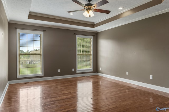 16121 Kyle Moran Dr, Athens, AL 35614 - spare room with a tray ceiling, wood finished floors, ornamental molding, a textured ceiling, and baseboards
