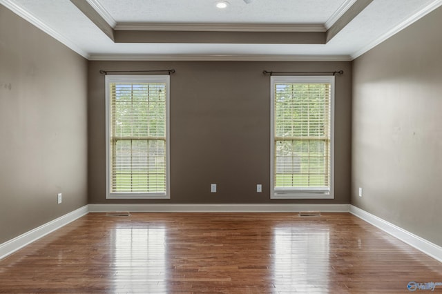 16121 Kyle Moran Dr, Athens, AL 35614 - spare room featuring healthy amount of natural light, wood finished floors, a raised ceiling, and crown molding