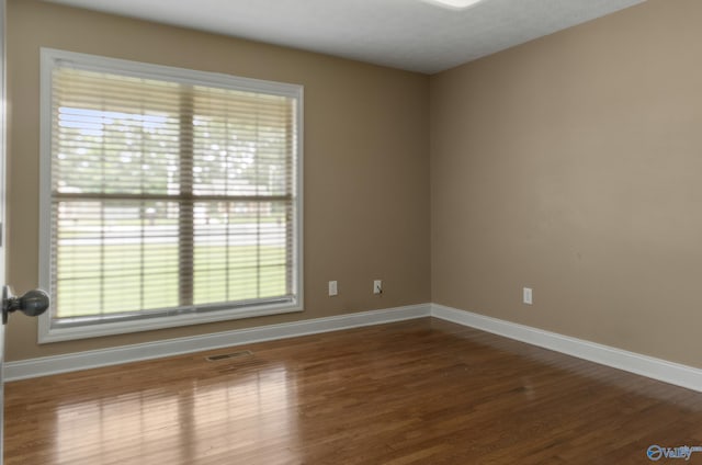 16121 Kyle Moran Dr, Athens, AL 35614 - empty room featuring baseboards, wood finished floors, and healthy amount of natural light