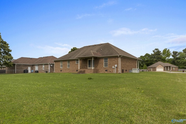 16121 Kyle Moran Dr, Athens, AL 35614 - back of house with brick siding, a lawn, and a detached garage