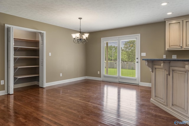 16121 Kyle Moran Dr, Athens, AL 35614 - unfurnished dining area with a chandelier, dark wood finished floors, a textured ceiling, baseboards, and recessed lighting