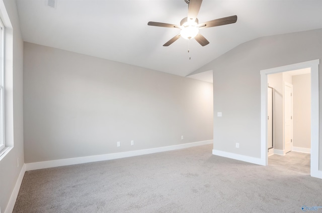 unfurnished room with ceiling fan, lofted ceiling, and light carpet