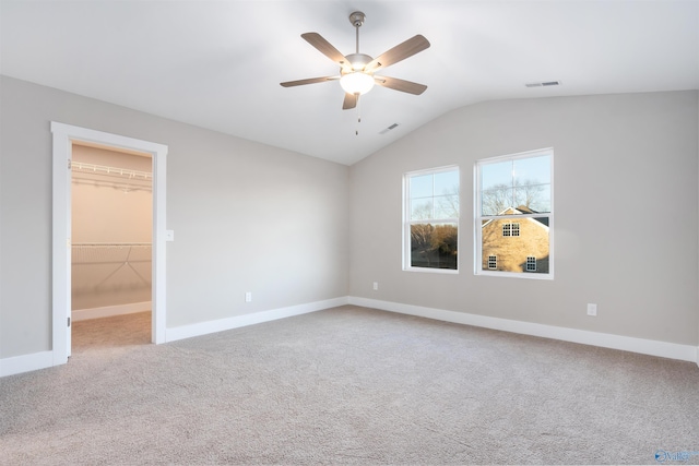 spare room with lofted ceiling, carpet flooring, and ceiling fan