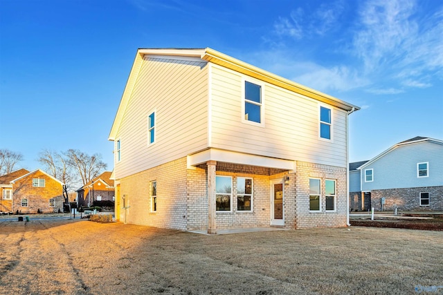 back of property featuring a lawn