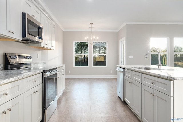 kitchen featuring white cabinetry, sink, crown molding, and stainless steel appliances