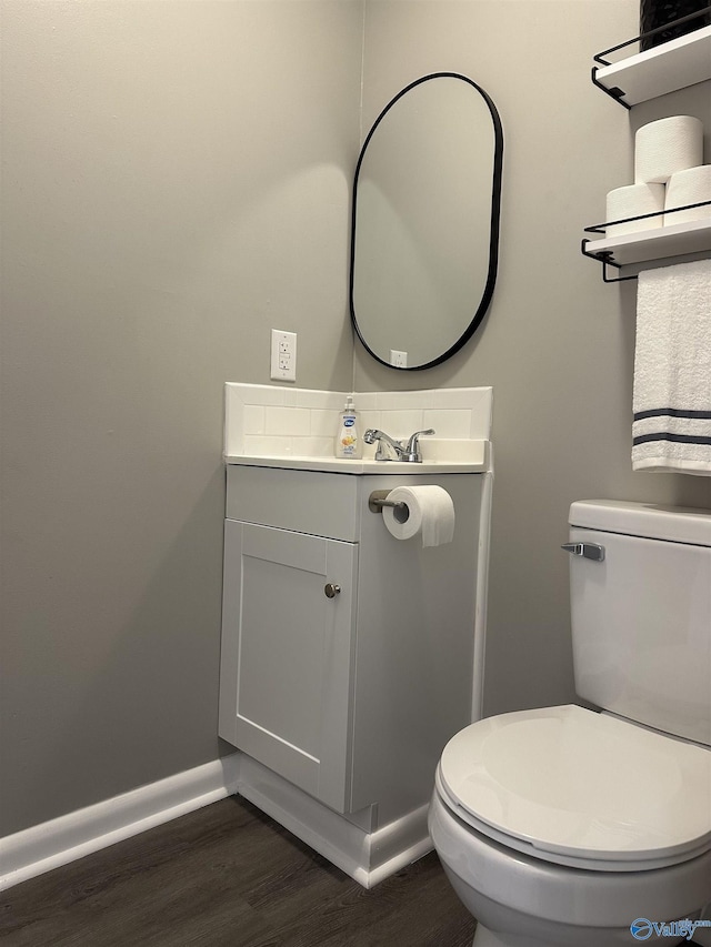 bathroom featuring vanity, toilet, and wood-type flooring