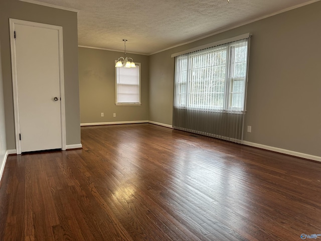 unfurnished room with dark wood-type flooring, ornamental molding, a chandelier, and a textured ceiling