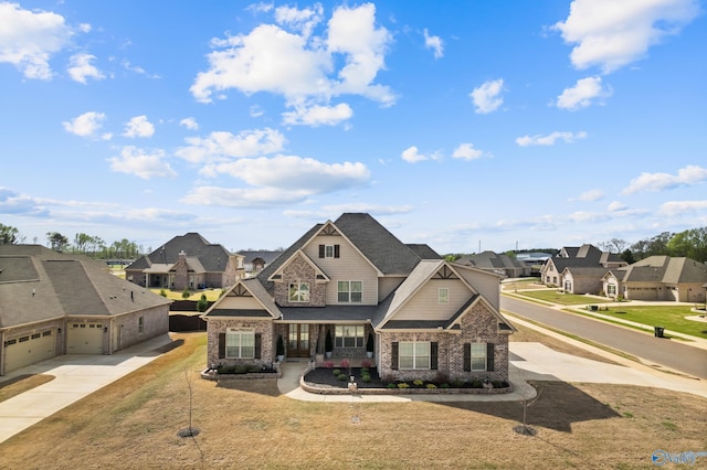 view of front of house featuring brick siding, stone siding, a residential view, and driveway