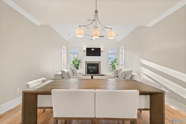 dining room featuring a wealth of natural light, light wood-style floors, and vaulted ceiling