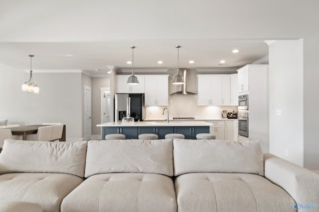 living area featuring recessed lighting, an inviting chandelier, and crown molding