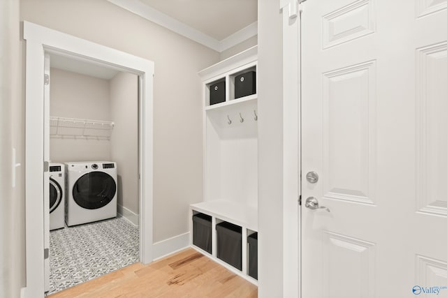 mudroom with crown molding, independent washer and dryer, light wood finished floors, and baseboards