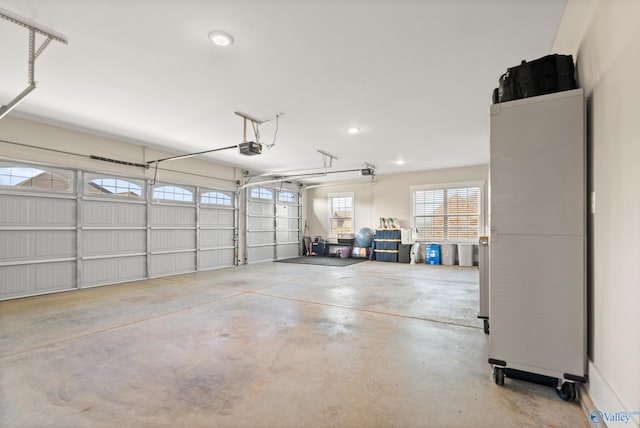 garage featuring a garage door opener and recessed lighting