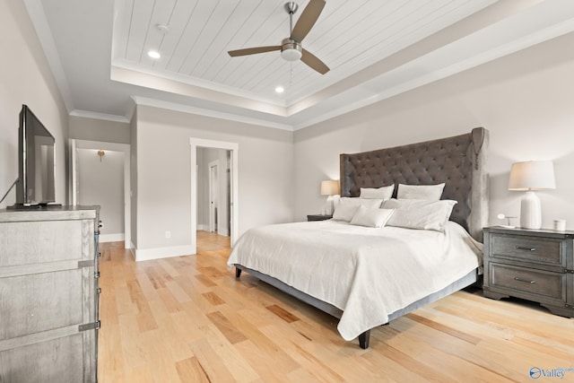 bedroom featuring a tray ceiling, light wood-type flooring, ornamental molding, wood ceiling, and baseboards