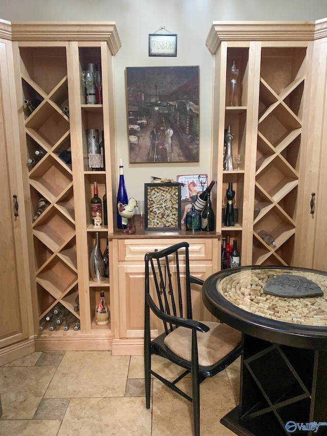 wine room featuring a dry bar and stone finish flooring