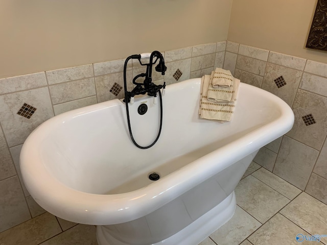 bathroom featuring a soaking tub, tile walls, and tile patterned floors