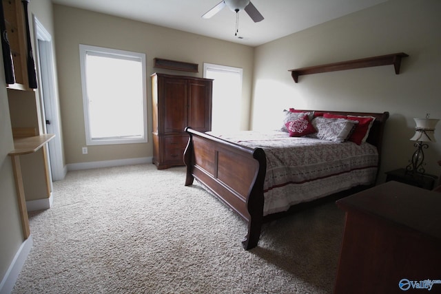 bedroom featuring light colored carpet and ceiling fan