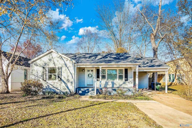 single story home featuring a front yard and a carport