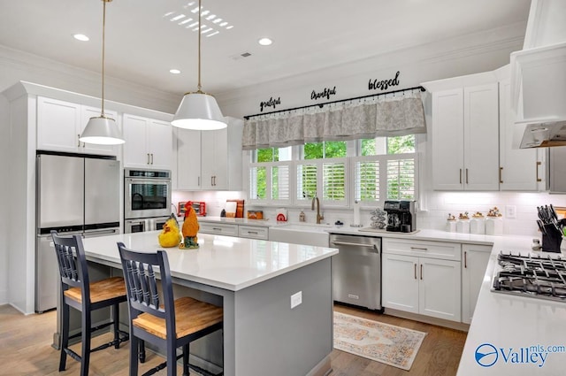 kitchen featuring a sink, tasteful backsplash, ornamental molding, and stainless steel appliances