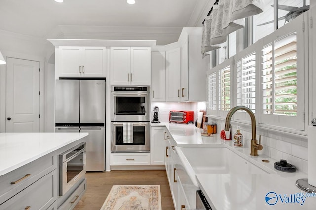 kitchen with light countertops, tasteful backsplash, and stainless steel appliances