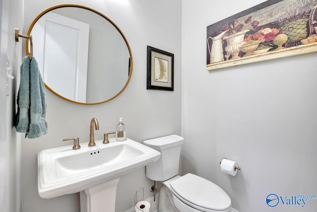 half bath featuring a sink and toilet