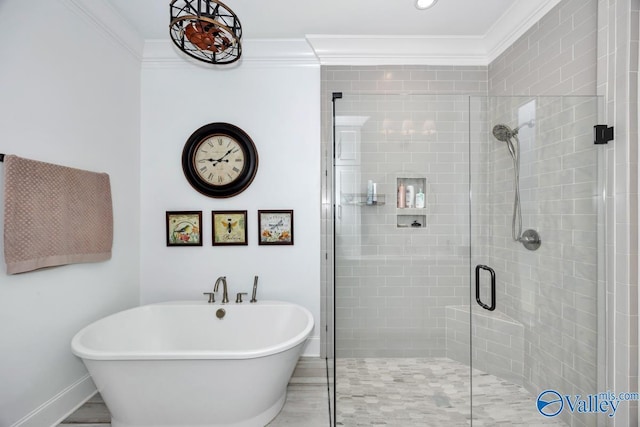 bathroom featuring crown molding, a freestanding tub, baseboards, and a stall shower