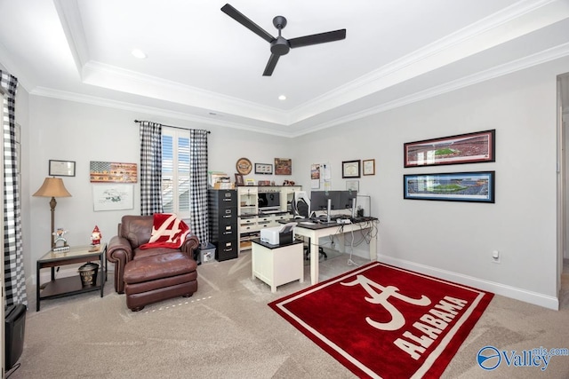 office area with carpet floors, crown molding, a tray ceiling, and ceiling fan