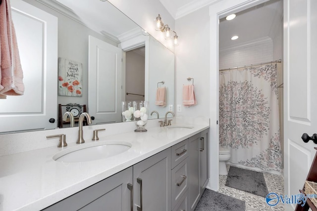 bathroom with a sink, crown molding, toilet, and double vanity