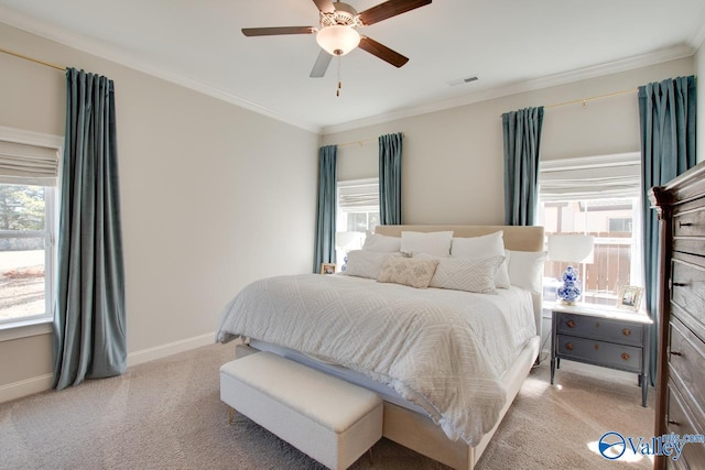 bedroom with light carpet, multiple windows, baseboards, and crown molding